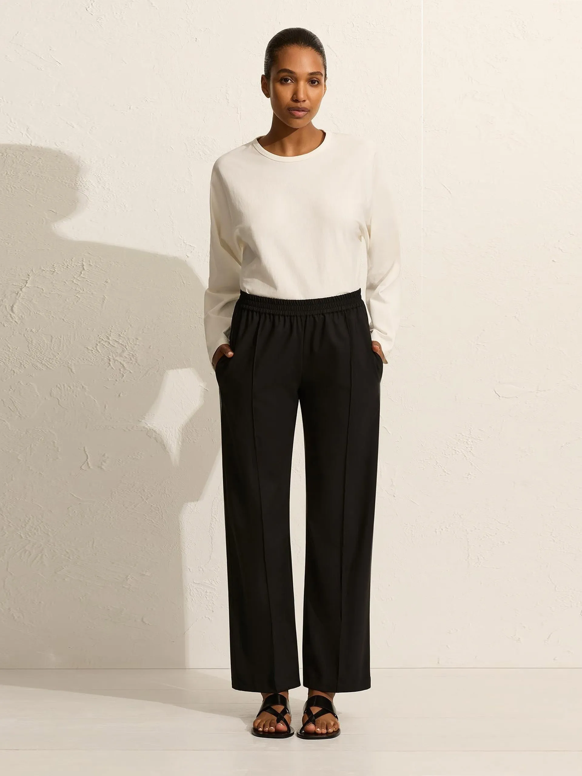 Black relaxed pin-stitch trousers